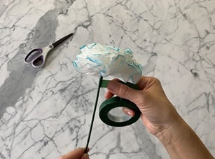 Step 8: Attaching pipe cleaner stem to faux floral stem using floral tape