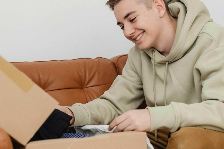 College student opening up a care package