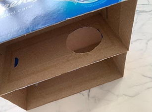 Step 2: Cutting identical circles in both Kleenex boxes for the pole