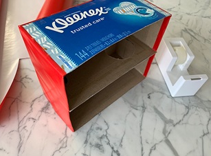 Step 4: Wrapping red paper all the way around the sides of the Kleenex box